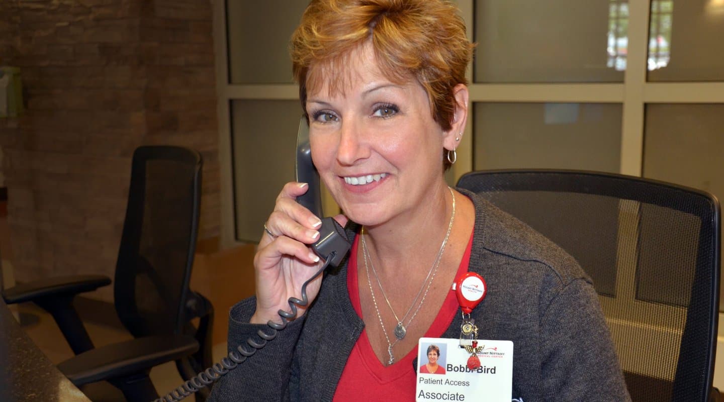 Woman smiles while answering a phone call