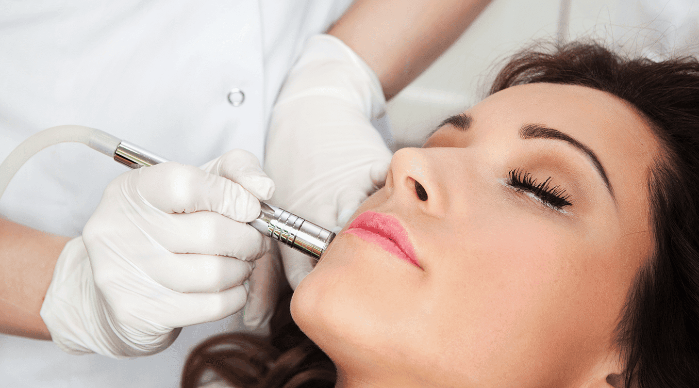 close up of woman's face receiving treatment from a medical professional at a med spa
