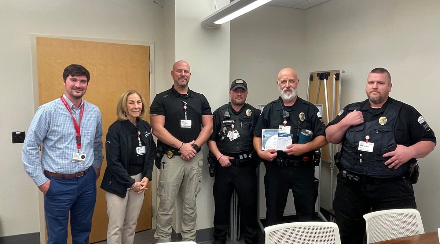 Security Officers pose for a picture in a conference room.