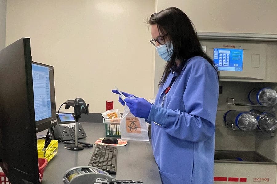 Women looks at lab equipment