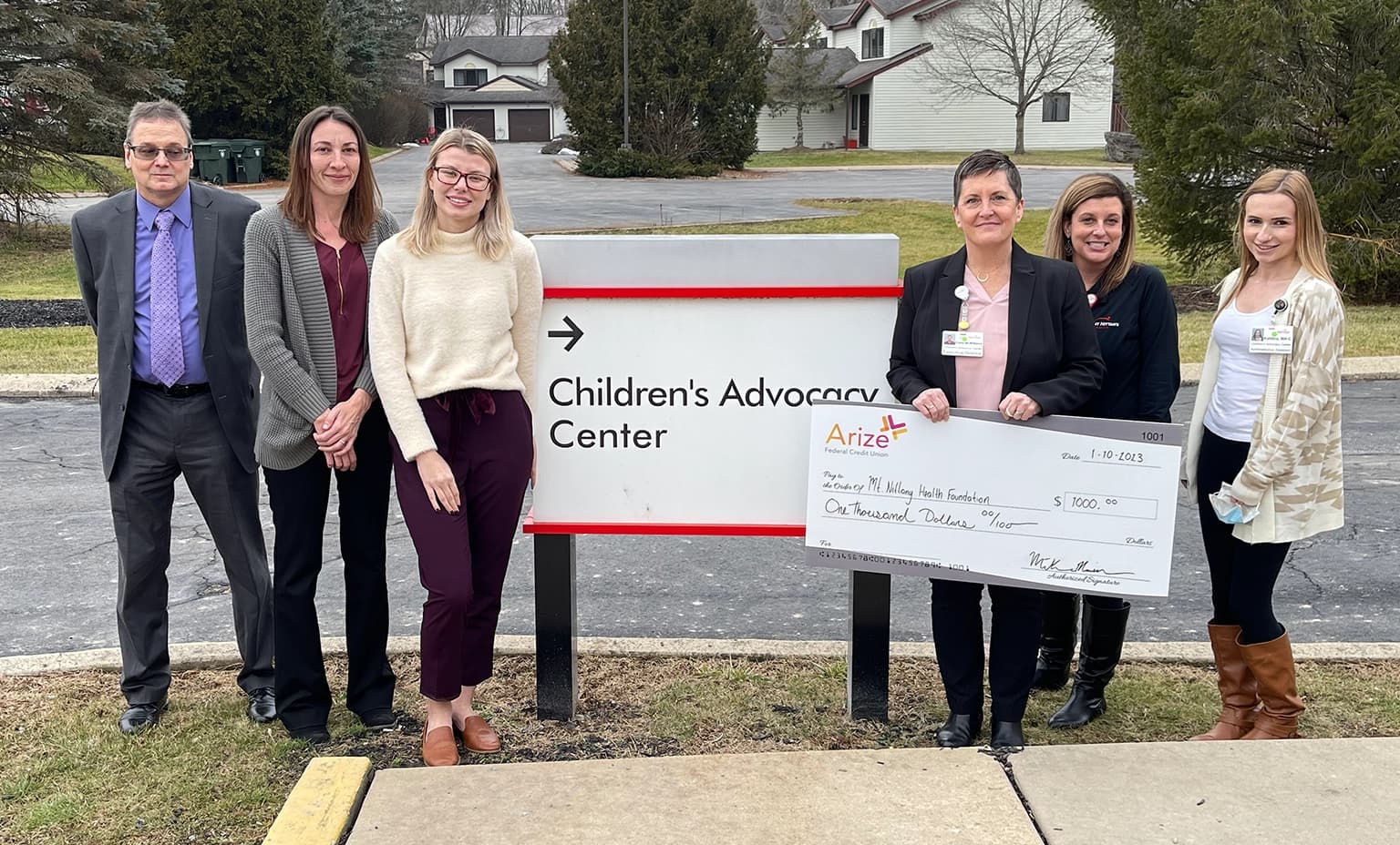 Representatives from Arize Federal Credit Union present check to the CAC