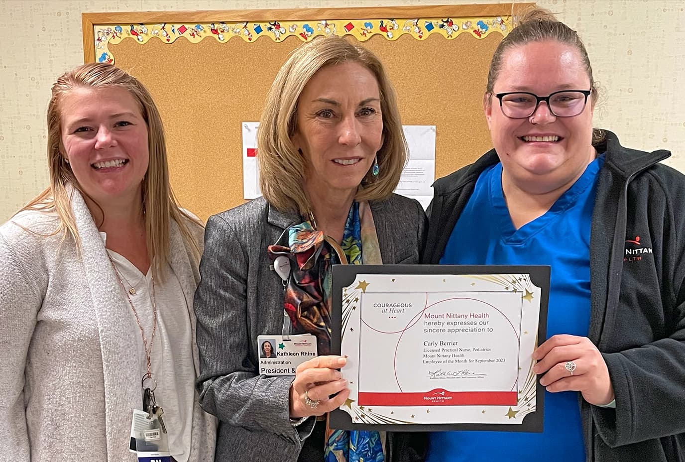 Carly poses with her employee of the month certificate