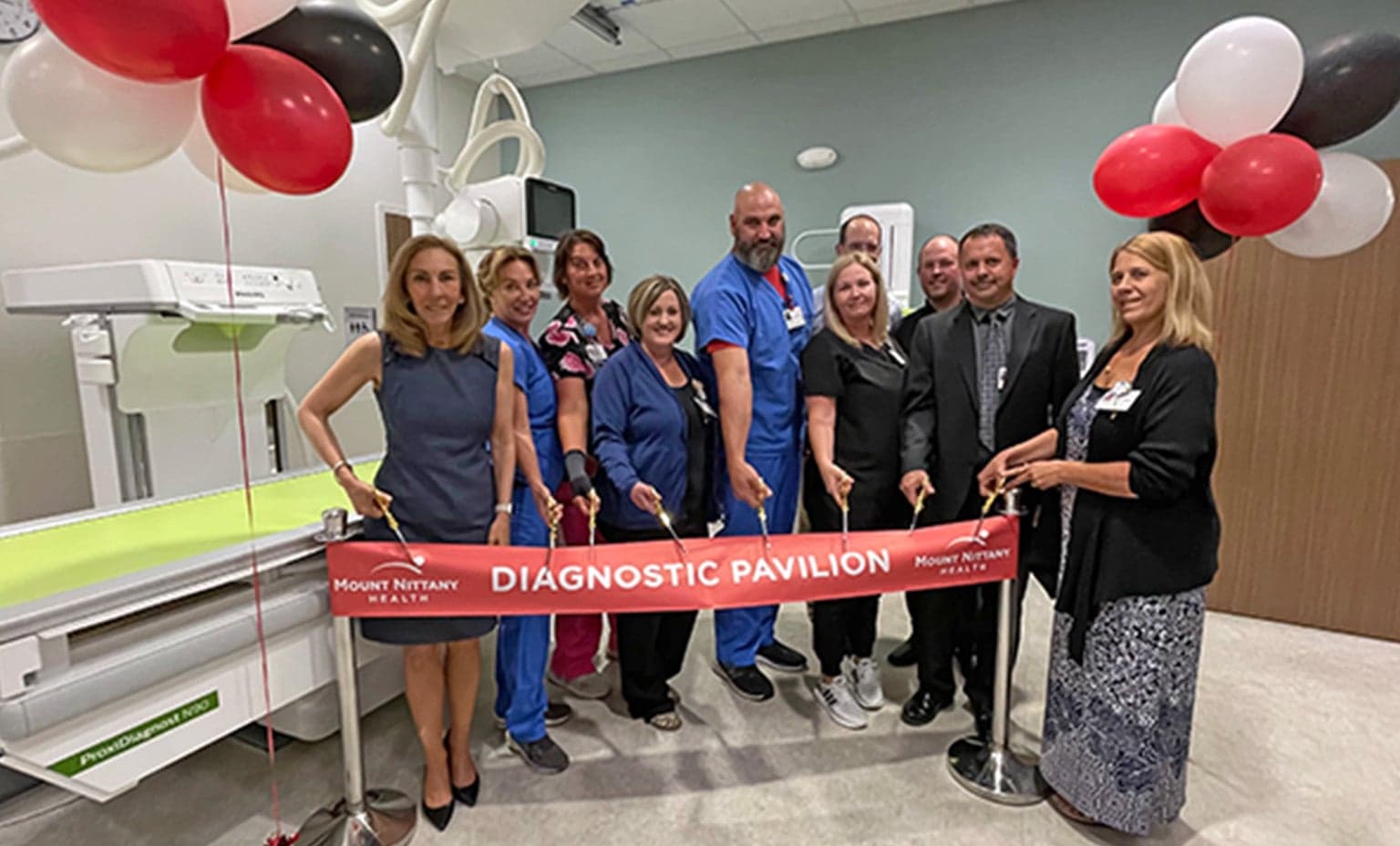 People prepare to cut the ribbon at the Diagnostic Pavilion