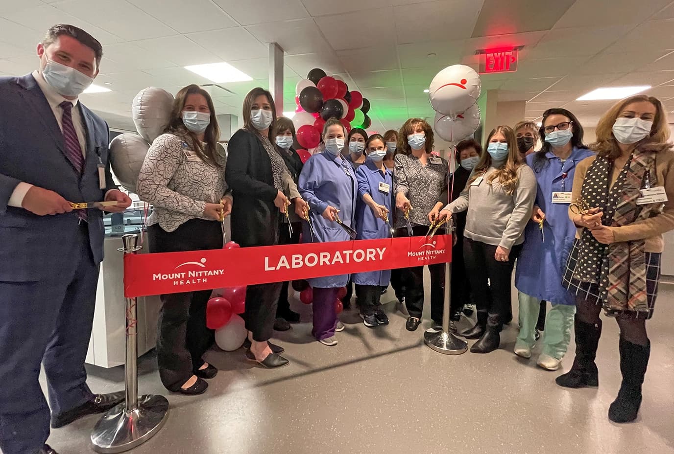 People prepare to cut the ribbon in the new lab