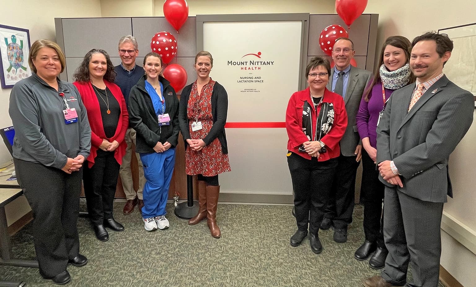Members of the Women and Children's Unit standby for a ribbon cutting at the Schlow library lactation space