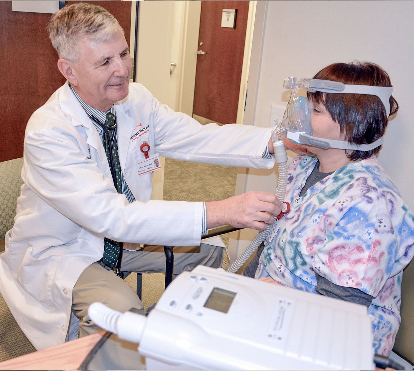 Physician fits a CPAP to a patient