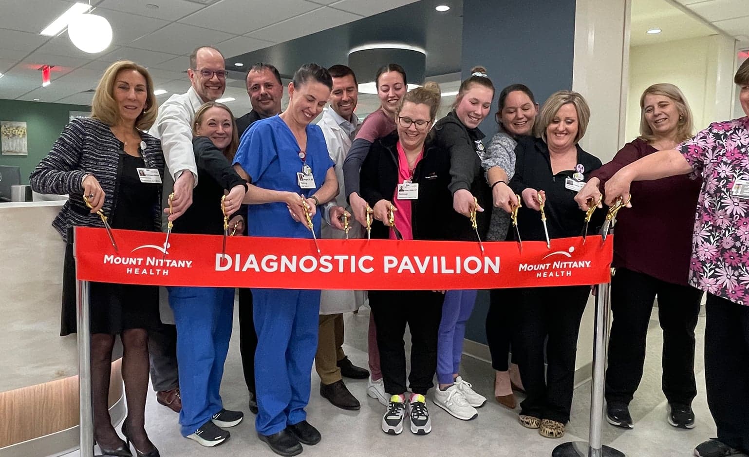 Staff cut the ribbon for the diagnostic pavilion with golden scissors