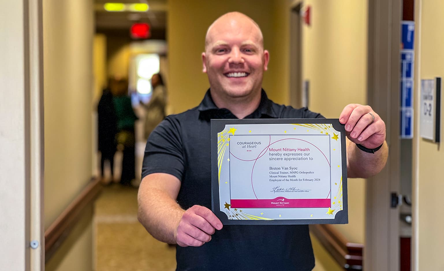 Breton Van Syoc holds his employee of the month certificate