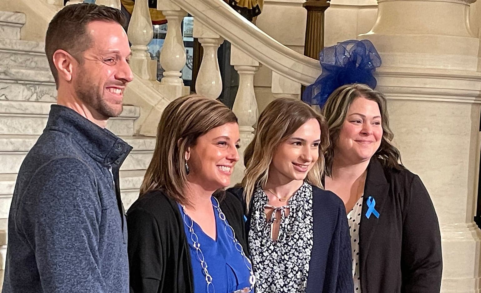 Kim Saltsman poses at the bottom of the capitol steps with fellow CAC representatives