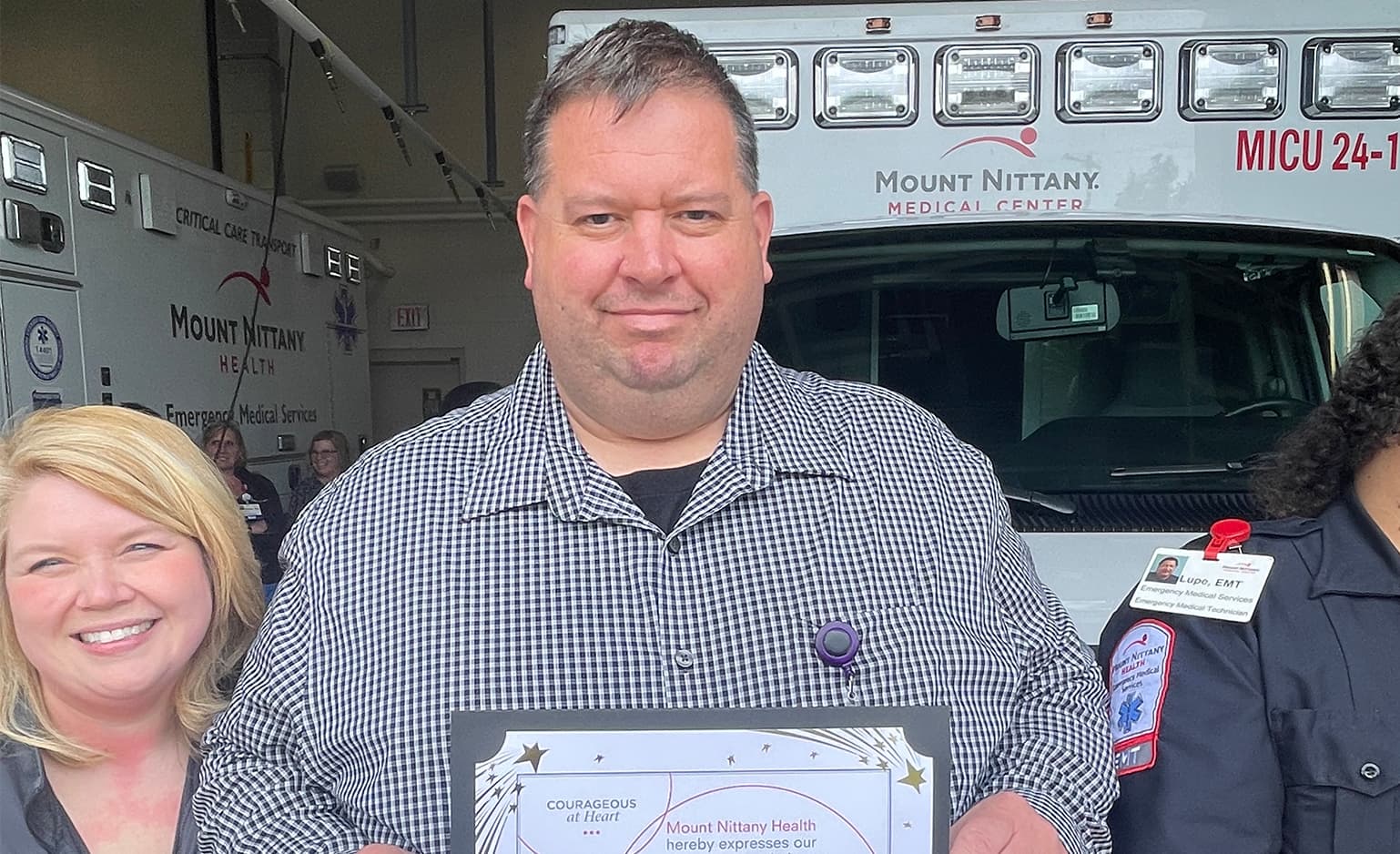 Chris Hockenberry, EMT holds his employee of the month certificate