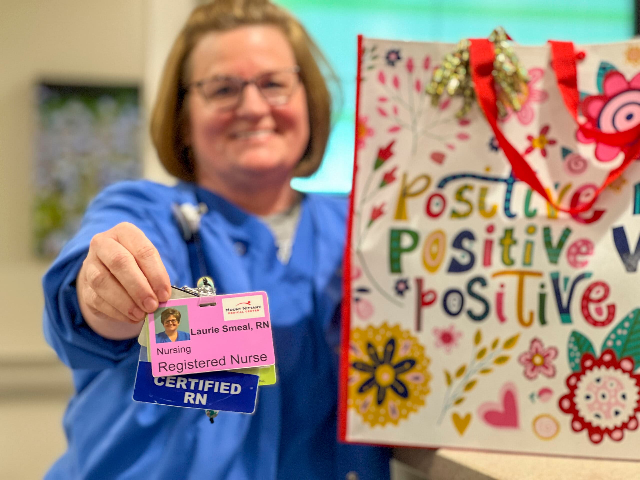 Laurie Smeal, RN poses with her service aware during National Nurses Week