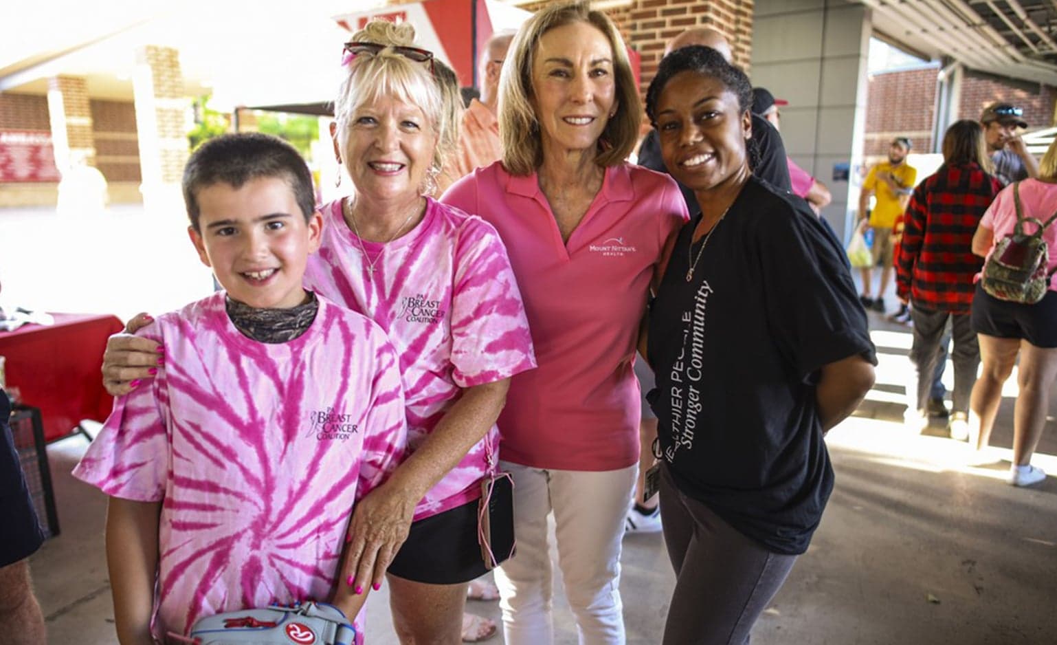 Kathleen Rhine and Dr. Burns-Johnson pose with breast cancer survivor at Paint the Park Pink