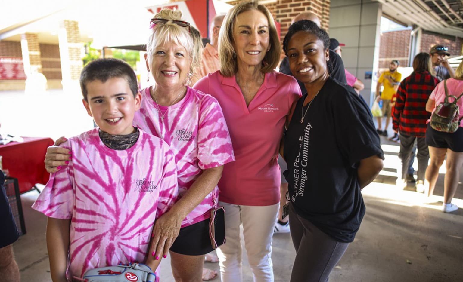 Kathleen Rhine and Dr. Burns-Johnson pose with breast cancer survivor at Paint the Park Pink