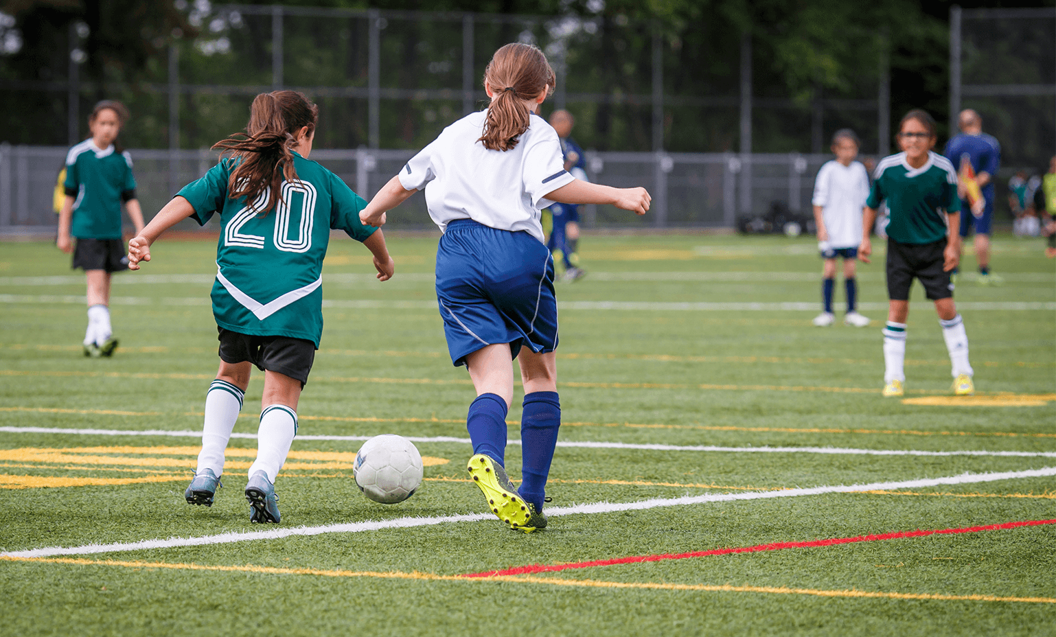 Young girls playing soccer.