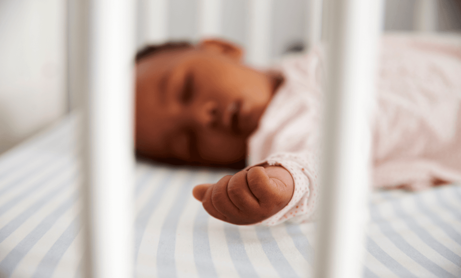 Baby sleeping safely in crib.
