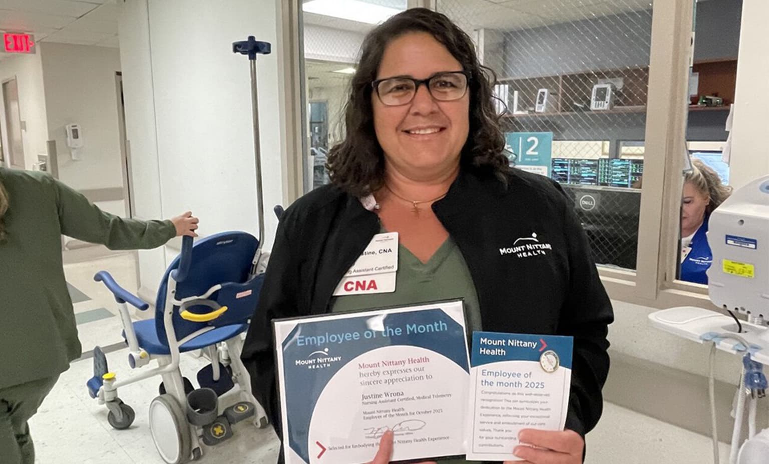 Justine Wrona, CNA poses with her employee of the month certificate