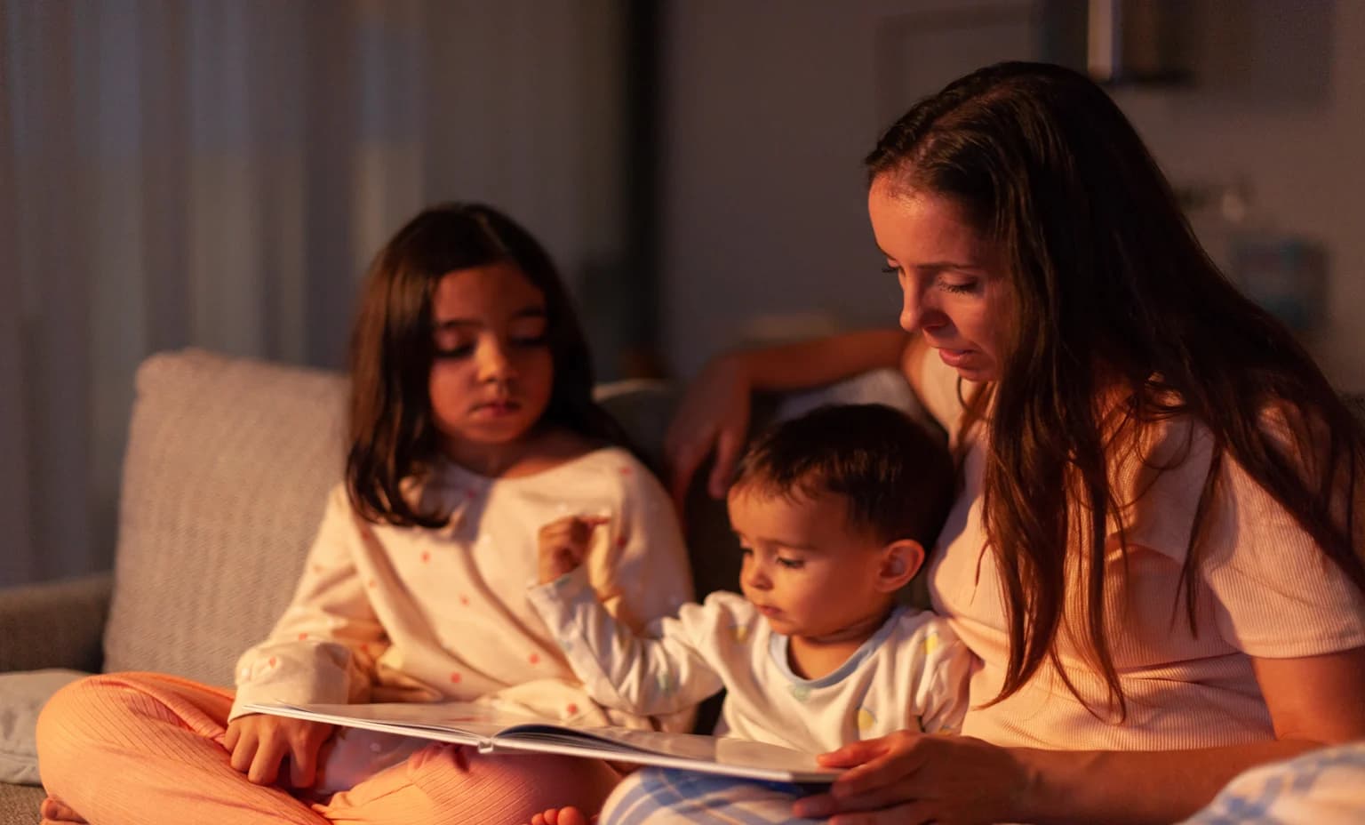 Mom telling a story to her children at night