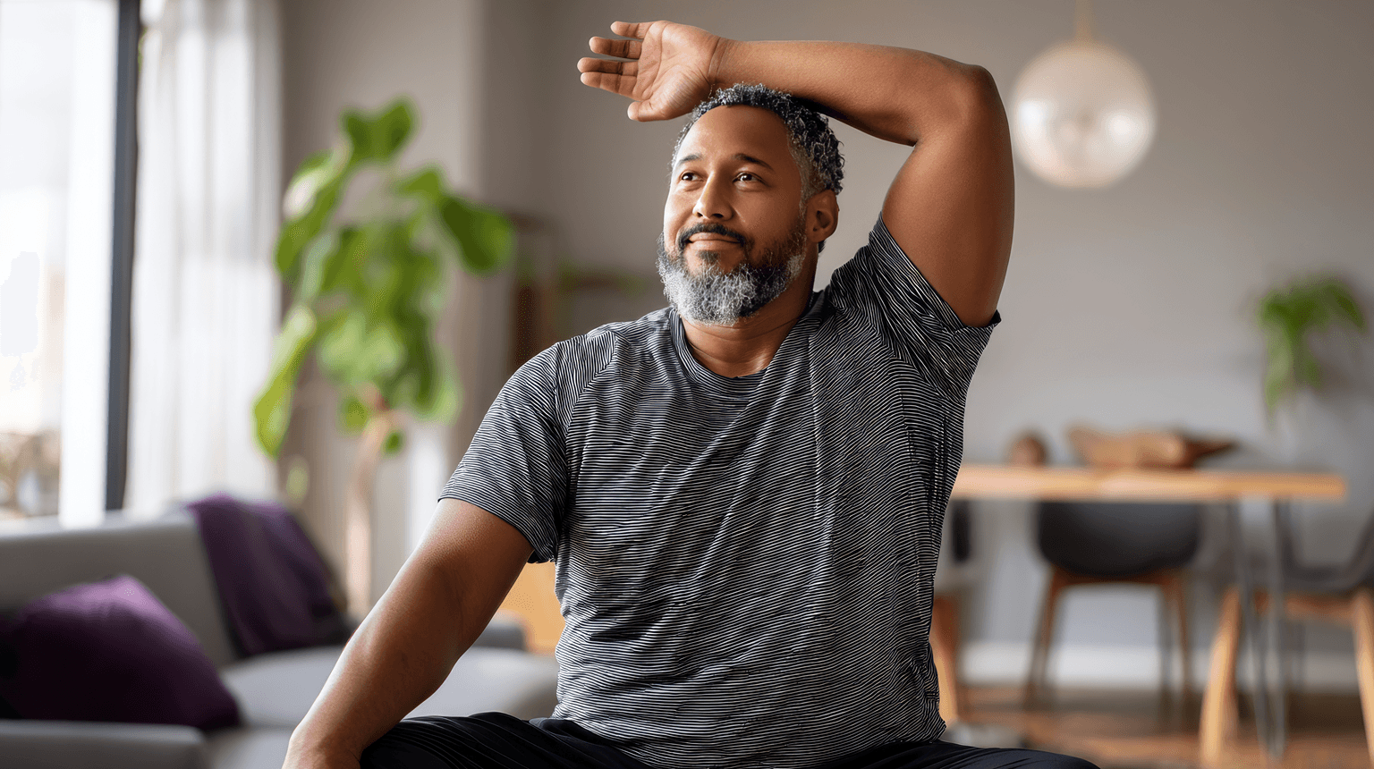 a man sitting in his home looking happy