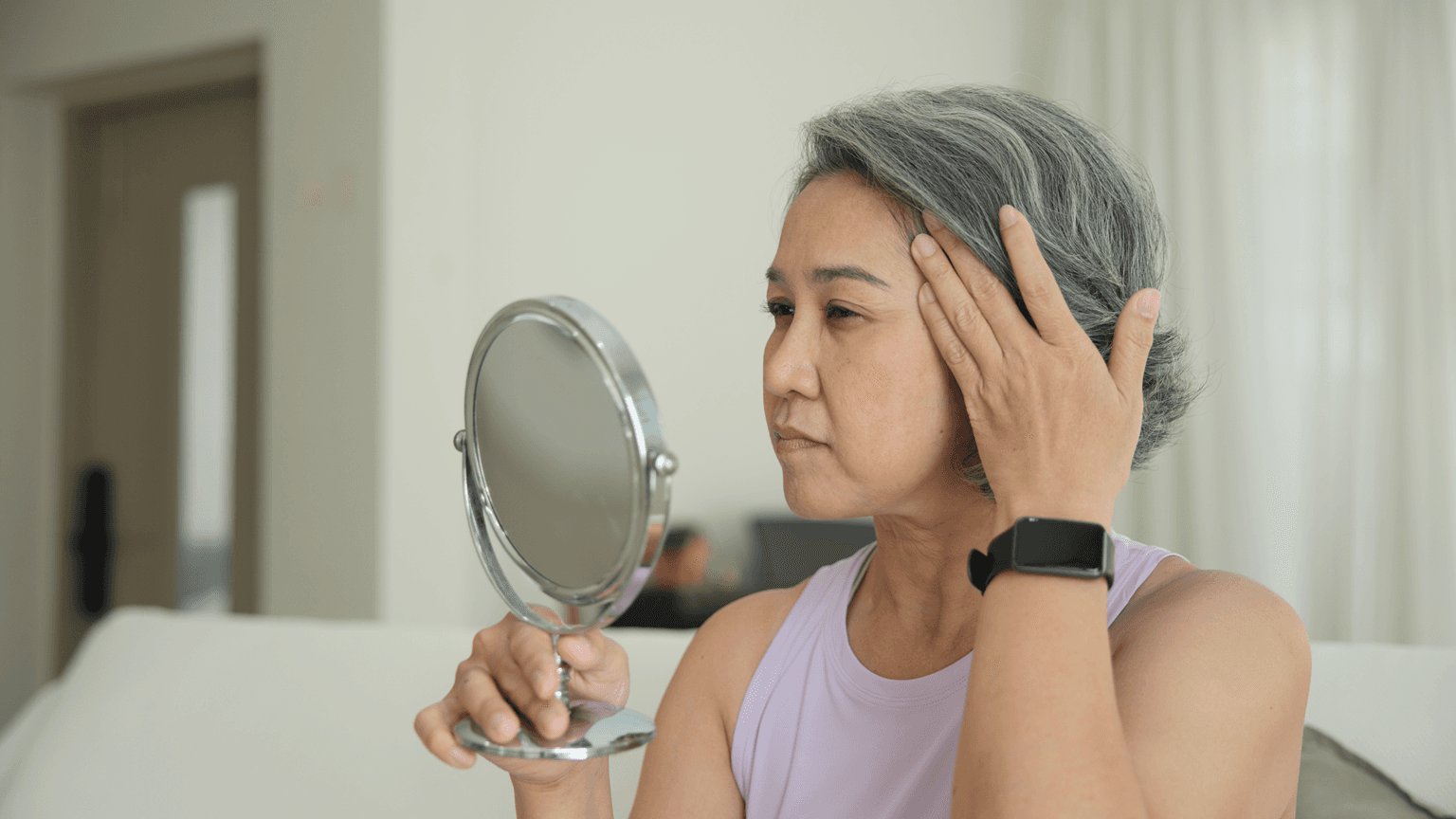 middle age woman look at mirror