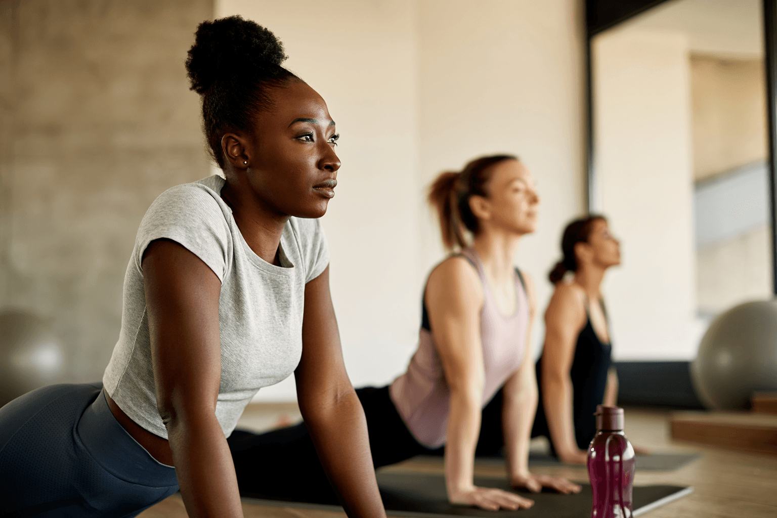 woman stretching during exercise class at health club