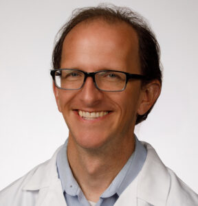Daniel Pitts, MD smiles for a professional headshot photo