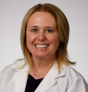 Georgia Hetrick smiles and wears her white coat