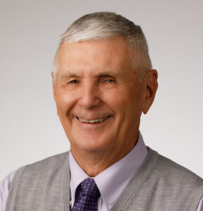 John Solic, MD smiles for a professional headshot photo