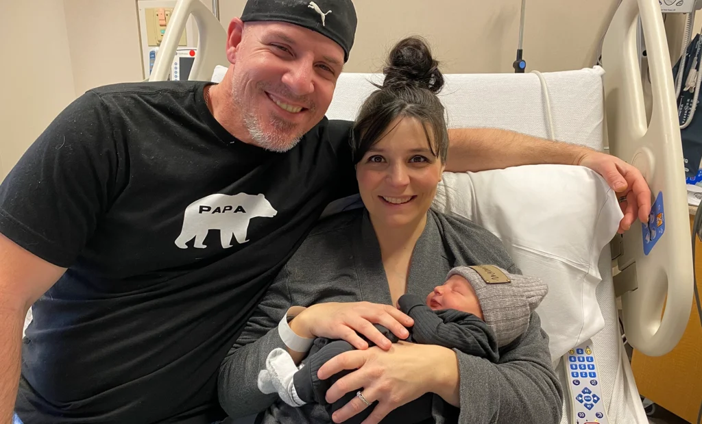 New parents pose with the first baby born at Mount Nittany Medical Center in 2023