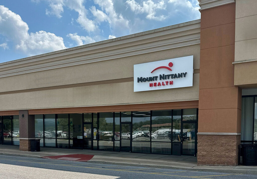 Photo of a shopping center with the Mount Nittany Health logo sign in Huntingdon