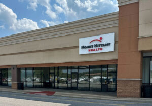 Photo of a shopping center with the Mount Nittany Health logo sign in Huntingdon