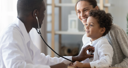Doctor uses stethoscope to listen to a child's heartbeat