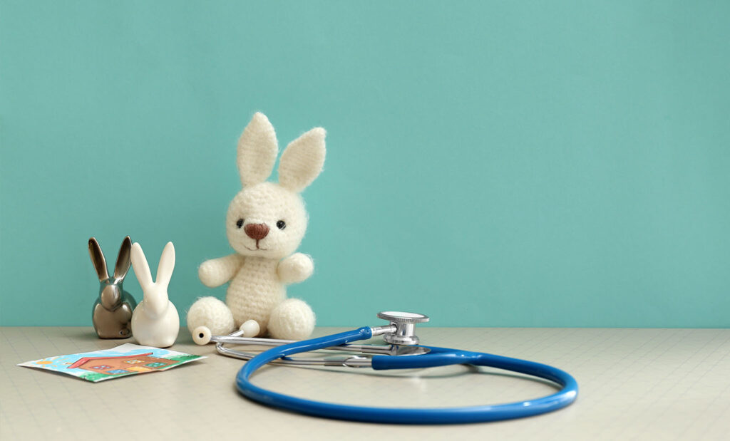 Children's toys on a table next to a stethoscope