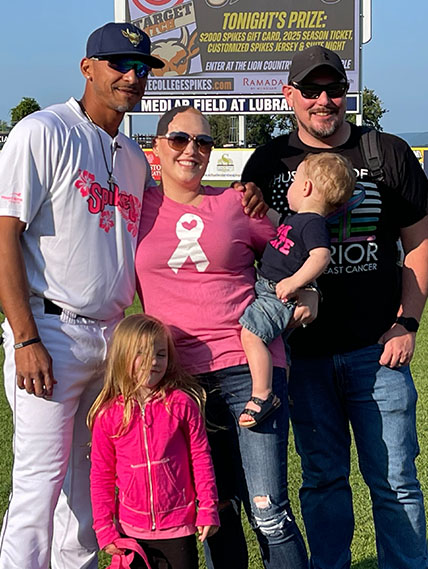 Pam Crants poses with her family and Spikes players during Paint the Park Pink Event