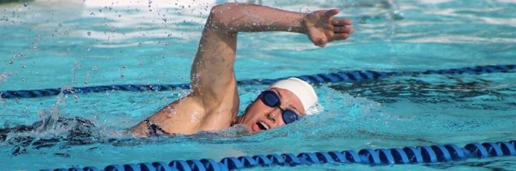 Swimmer turns head to breathe in swimming lane
