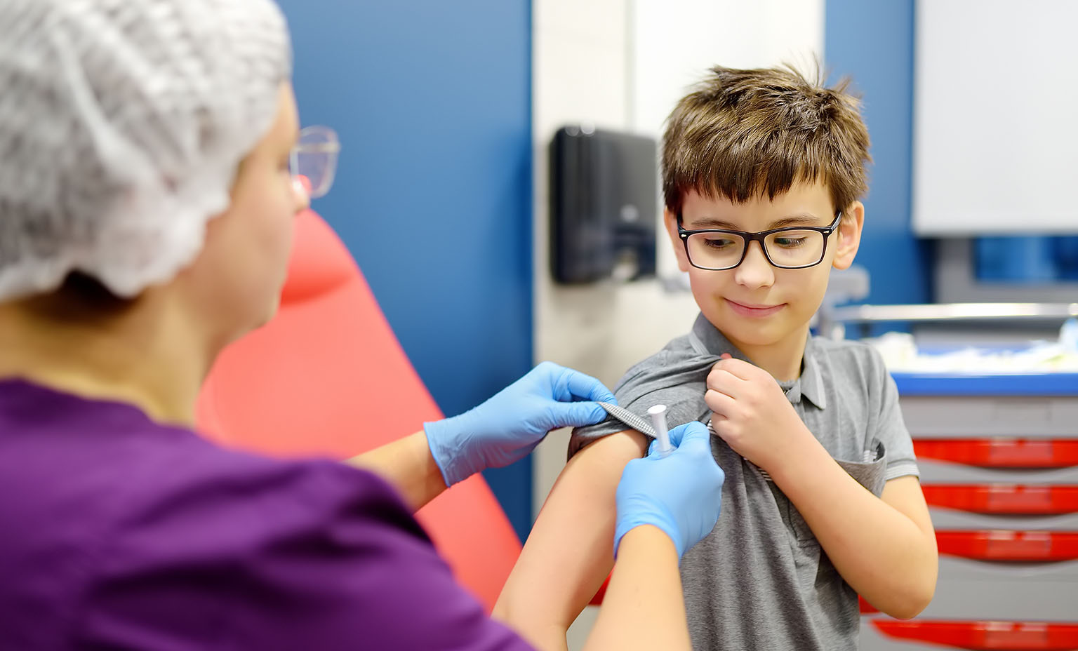 Nurse prepares to give a child a shot