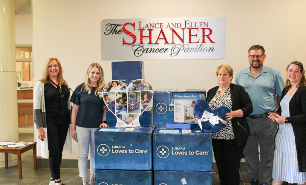 Stocker Subaru and Mount Nittany Health Foundation staff post with boxes of blankets