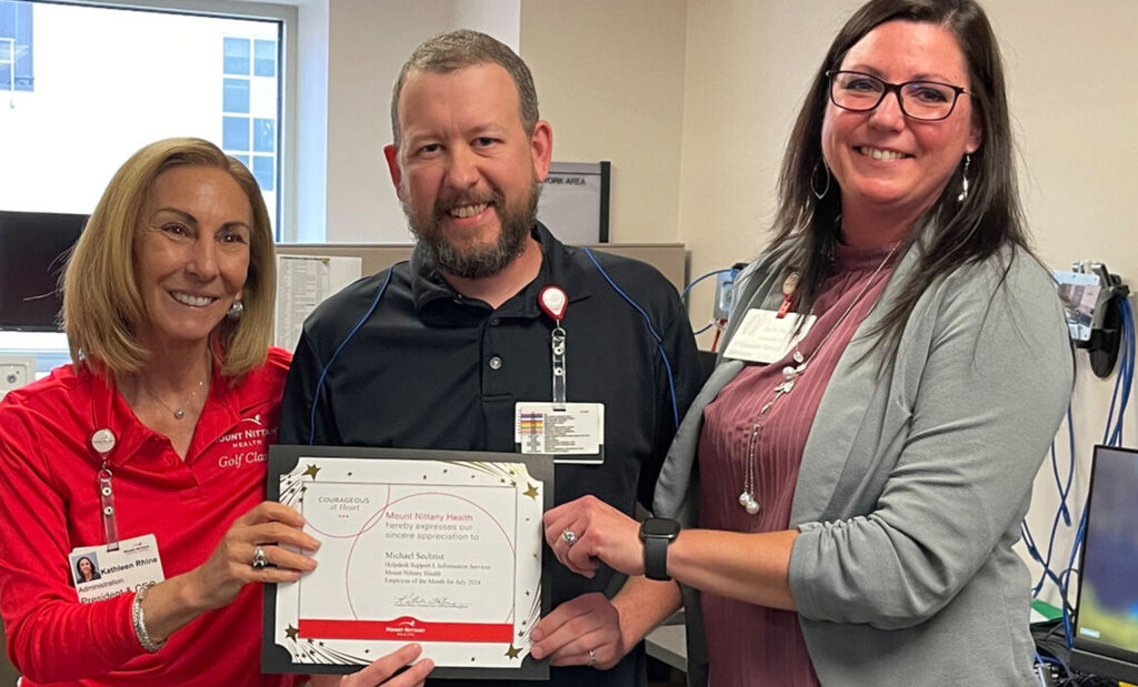 Mike Sechrist poses with his employee of the month certificate