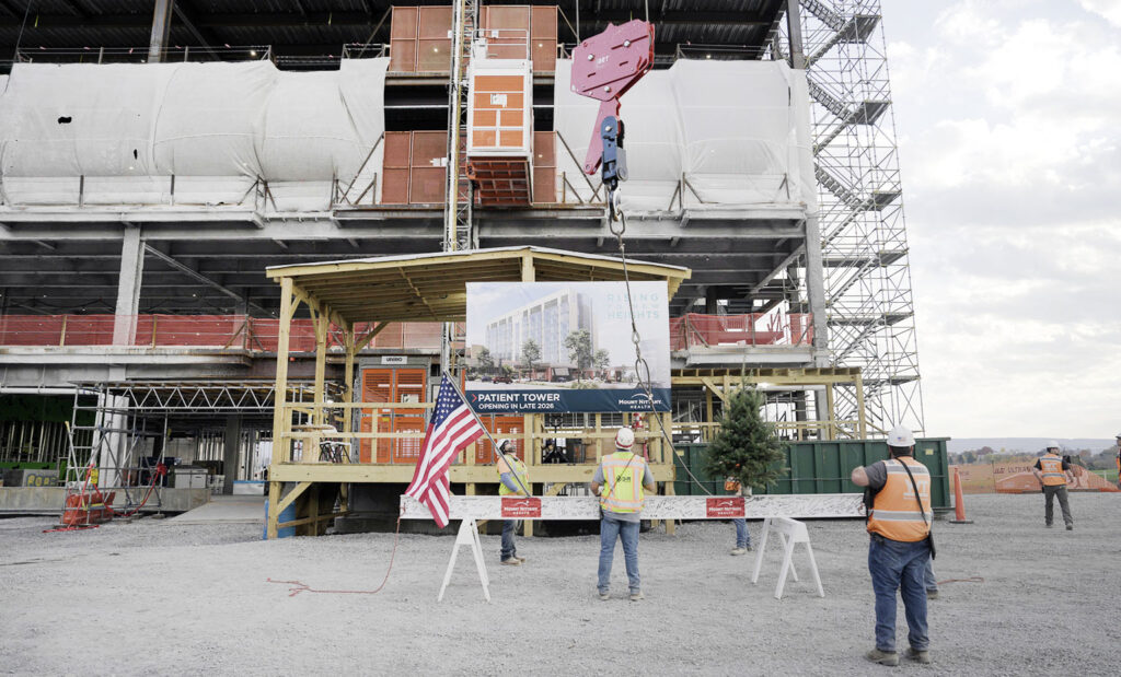 The last steel beam is raised and placed at the new patient tower at Mount Nittany Medical Center