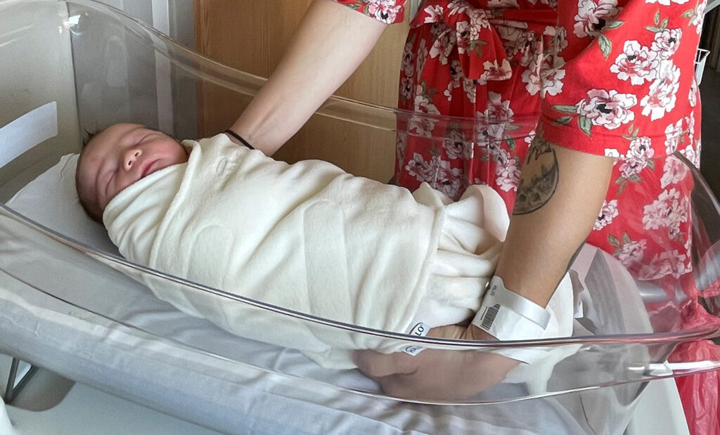 Newborn baby wrapped in a sleep sack