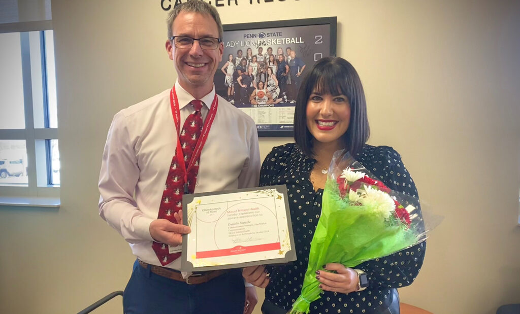 Kurt Kissinger presents Danielle Stemple with the Employee of the Month certificate