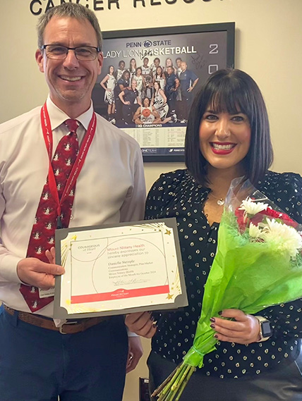Kurt Kissinger presents Danielle Stemple with the Employee of the Month certificate