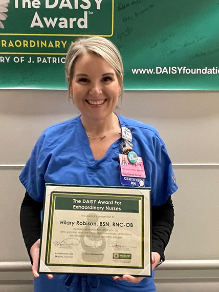 Hilary Robison poses with her DAISY award