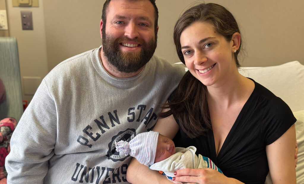 Proud parents pose with the 2025 New Year's Baby!