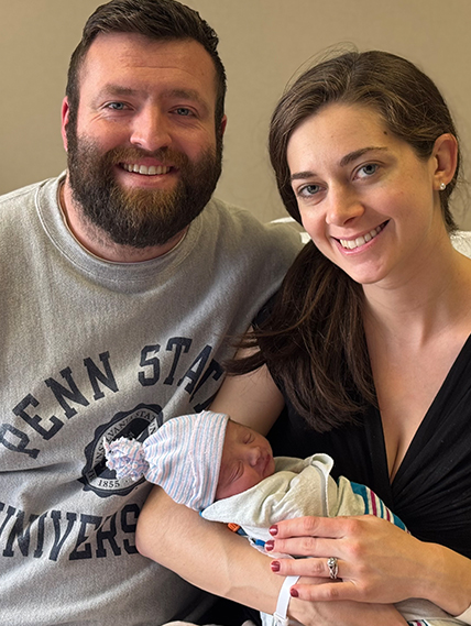 Proud parents pose with the 2025 New Year's Baby!