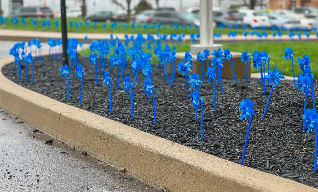 Blue pinwheels planted in the ground at Mount Nittany Medical Center