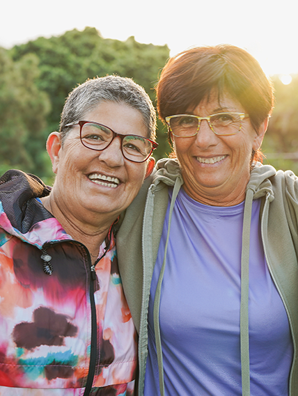 Two middle-aged women hugging.