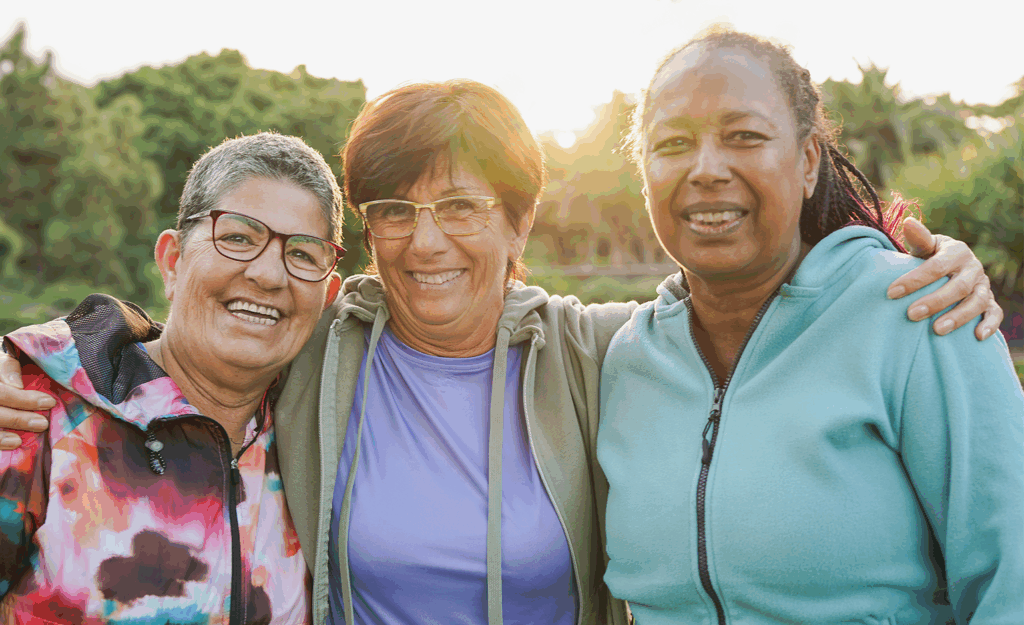 Three middle-aged women hugging.