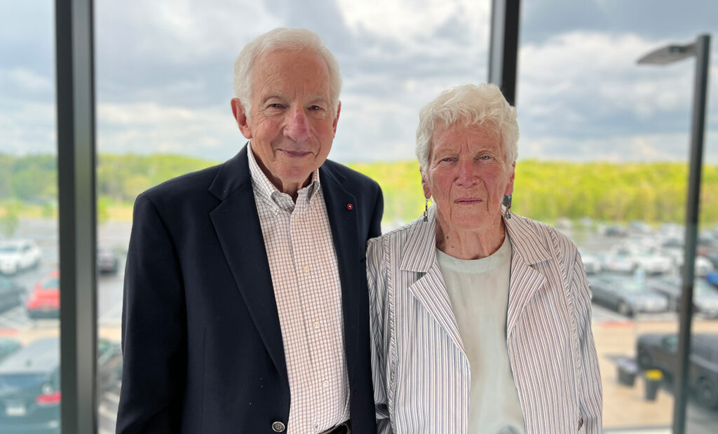 Stephen and Patricia Benkovic pose for a photo in front of a window