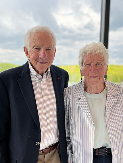 Stephen and Patricia Benkovic pose for a photo in front of a window