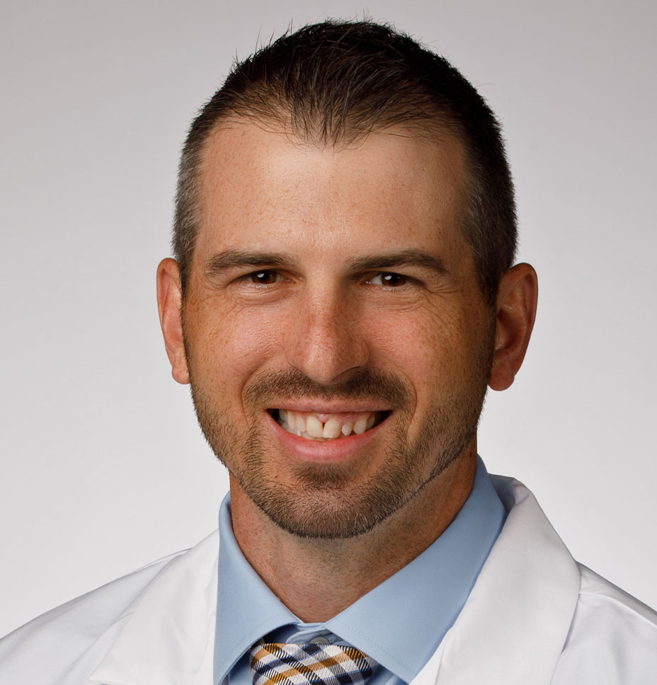 Joshua Smith, PA-C wears a white coat and smiles for a professional headshot photo